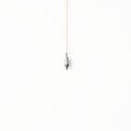 Metallic Plumb Bob Hanging from Thin Golden Chain Against White Background Royalty Free Stock Photo