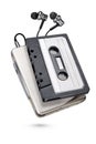 Metallic portable player with earbuds and cassette tape isolated