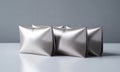 Metallic pouches with textured pattern on gray background. Minimal studio shot Royalty Free Stock Photo
