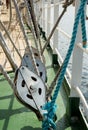 Metallic pulley block and ropes on the deck of a sailing ship Royalty Free Stock Photo