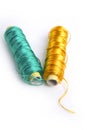 Metallic rayon thread line spool green and gold Royalty Free Stock Photo