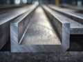 Metallic rectangular channel beams stacked in an industrial setting with visible brushed texture highlighting sturdy construction Royalty Free Stock Photo