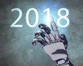 Metallic robot hand touches date of new year 2018. Royalty Free Stock Photo