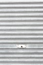 Metallic roller shutter with door lock