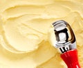 Metallic scoop on creamy banana yellow ice cream Royalty Free Stock Photo