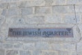 Metallic sign of jewish quarter written in english language outside on the street in multi cultural historical city of Toledo,