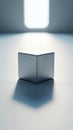 Metallic silver cube on flat surface under bright square spotlight casting long dramatic shadow art Royalty Free Stock Photo