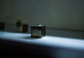 a square silver object on the counter is illuminated by light from underneath Royalty Free Stock Photo