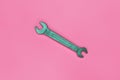 Metallic spanner lie on texture background of fashion pastel pink color paper in minimal concept Royalty Free Stock Photo