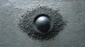 Metal Sphere in Graphite Powder on Slate Surface Royalty Free Stock Photo