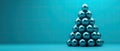 Metallic spheres in a pyramid shape on a turquoise background Royalty Free Stock Photo
