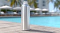 A metallic spray can by a poolside with blurred background. Royalty Free Stock Photo
