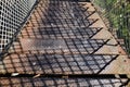 Metallic stairs on an iron bridge across a railway