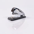 Metallic stapler for stapling sheets of paper with reflection