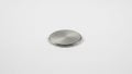 Metallic surface. Likely representative of a button cell battery Royalty Free Stock Photo