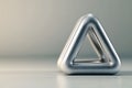 Metallic Triangular Object on Neutral Background