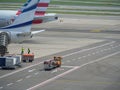 Metallic Trolleys Containing Meals ready to be Boarded On the Flight Line Airplane near the Runway