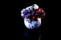 metallic vase with white red blue flowers . with reflection, black background isolated Royalty Free Stock Photo
