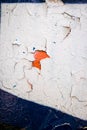 Metallic wall of white and blue color and with paint peeling of texture in orange spot. Copy space. Background for design