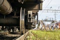 Wheel of a railway car standing on the rails on railway station close up Royalty Free Stock Photo