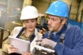 Metallurgic workers using tablet in factory Royalty Free Stock Photo