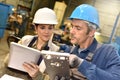 Metallurgic workers working with help of tablet Royalty Free Stock Photo