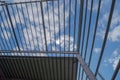 Steel skeleton of an industrial hall against a blue sky and tiny white clouds. Royalty Free Stock Photo