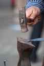 Metalsmith hammering the iron