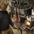 Metalsmith heating metal.