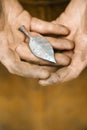 Metalsmith holding metal leaf. Royalty Free Stock Photo