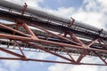 Metalwork of the farm of the pipeline through the air against the sky. The water supply system, heating, pneumomandrel Royalty Free Stock Photo