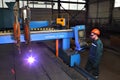 Metalwork Plant, worker controls system thermal cutting of metal