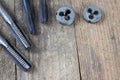 Metalwork tools on the workshop table. Threading dies and taps i Royalty Free Stock Photo