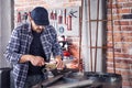 Metalworker cleaning off a metal pipe with a brush Royalty Free Stock Photo