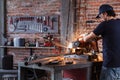 Metalworker grinding metal in a shower of sparks