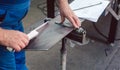 Metalworker measuring a strip of steel