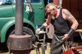 A metalworker at an outdoor forge