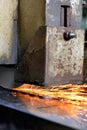 Metalworking industry: finishing metal working on horizontal surface grinder machine with flying sparks Royalty Free Stock Photo