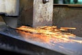 Metalworking industry: finishing metal working on horizontal surface grinder machine with flying sparks Royalty Free Stock Photo