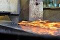 Metalworking industry: finishing metal working on horizontal surface grinder machine with flying sparks Royalty Free Stock Photo