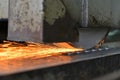 Metalworking industry: finishing metal working on horizontal surface grinder machine with flying sparks Royalty Free Stock Photo