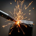 Metalworking process shown with a close-up of a welding tool creating bright orange Royalty Free Stock Photo
