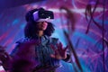 Metaverse digital cyber world technology, woman with virtual reality VR goggles playing augmented reality game