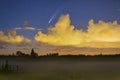 Meteor, shooting star or falling star seen in a night sky with clouds. Comet NEOWISE, C/2020 F3 Royalty Free Stock Photo