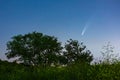 Meteor, shooting star or falling star seen in a night sky with clouds. Comet NEOWISE, C/2020 F3