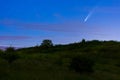 Meteor, shooting star or falling star seen in a night sky with clouds. Comet NEOWISE, C 2020 F3 Royalty Free Stock Photo