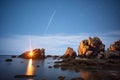 meteor shower over a rocky coastline at night Royalty Free Stock Photo