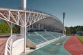 Meteor Stadium, empty rows of seats under canopy and red running tracks, landmark: Zhukovsky
