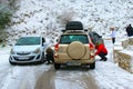 Drivers are mounting snow chains on their cars in wintry environment