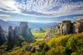 Meteora, Greece. Panoramic landscape of Meteora, Greece at romantic sundown time with real sun and sunset sky. Meteora - Royalty Free Stock Photo